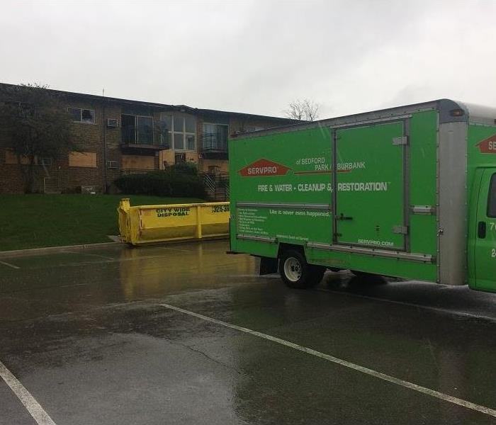 A SERVPRO truck parked outside an apartment building