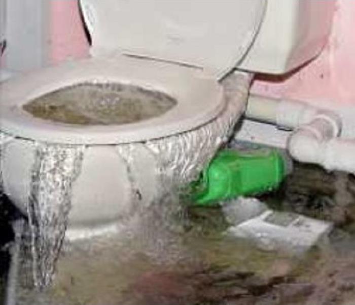 Water flowing up through a toilet