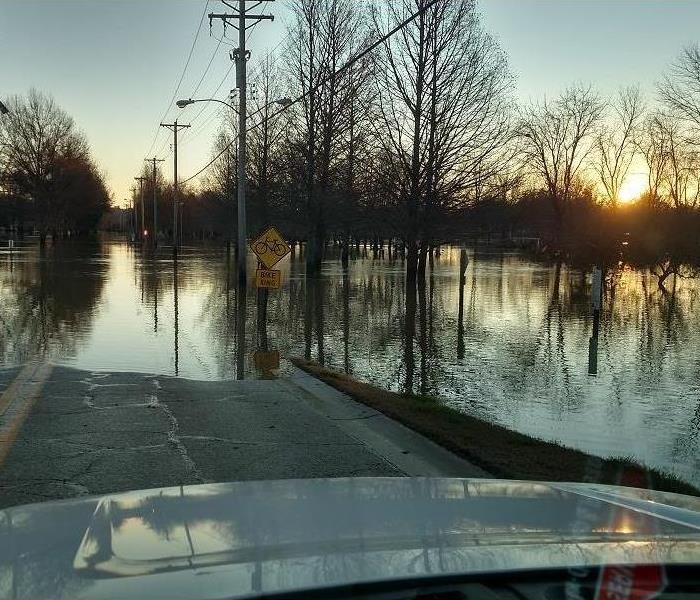 Sunset over a flooded road