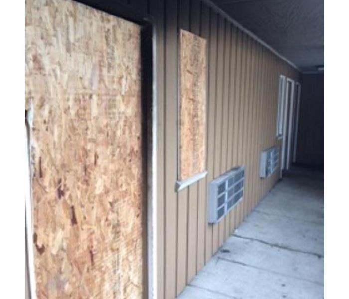 A door and window are boarded up