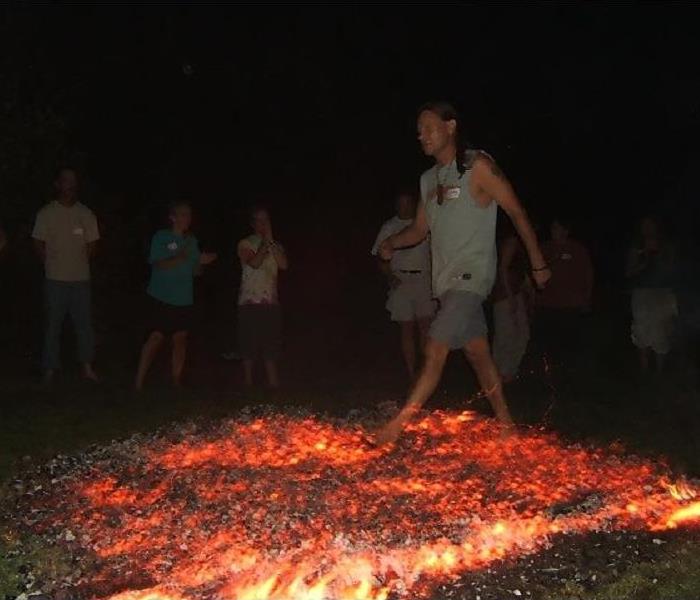 A person walking over hot coals