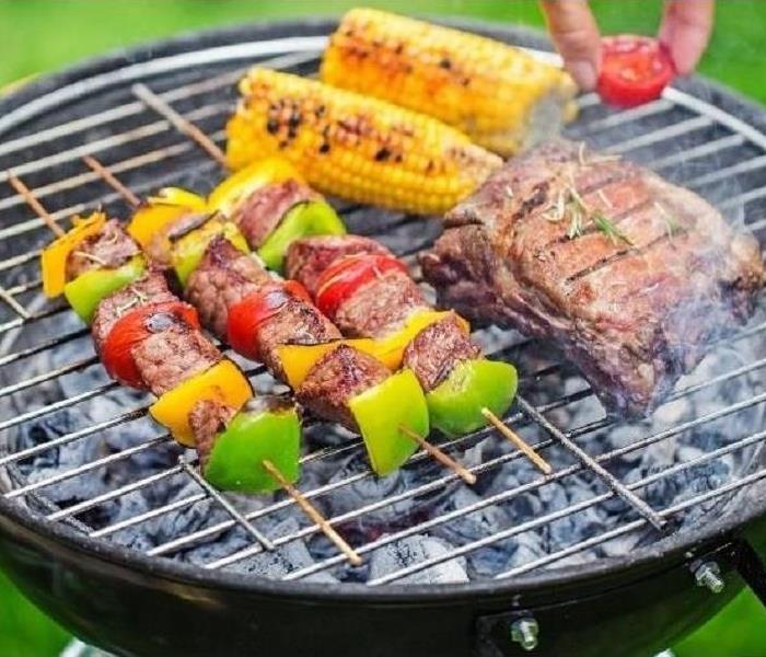 A grill full of meat and vegetables