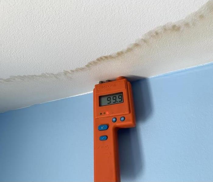 A moisture meter determining a wet ceiling