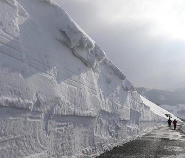 A huge snow drift on a country road