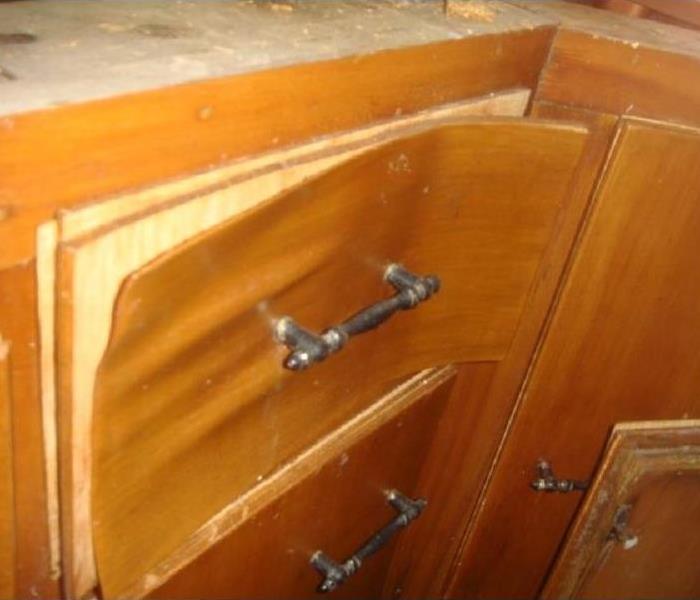 Wood delaminating from a drawer front from water damages