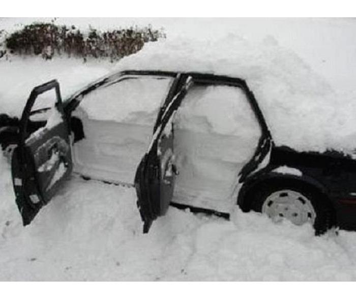 A car covered inside and out with snow